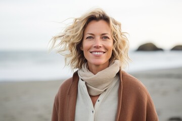 Medium shot portrait photography of a Swedish woman in her 40s against a beach background