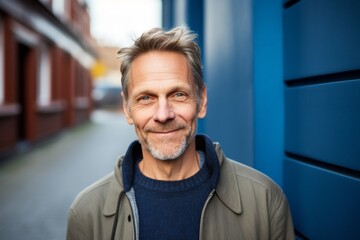Medium shot portrait photography of a Swedish man in his 50s against an abstract background