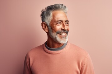 Portrait photography of a Peruvian man in his 50s against a pastel or soft colors background