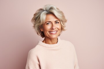 Fototapeta premium Group portrait photography of a French woman in her 50s wearing a cozy sweater against a pastel or soft colors background