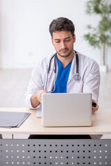 Young male doctor in telemedicine concept