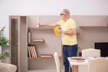 Old man doing housework at home