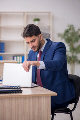 Fototapeta premium Young male employee working in the office
