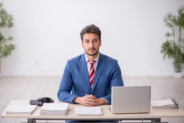 Young male employee working in the office