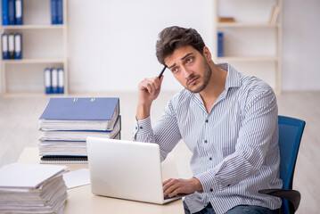 Young male employee working in the office