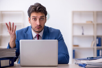 Young male employee working in the office