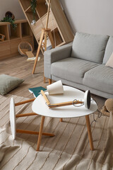 Tables with lamp and sofa in messy living room