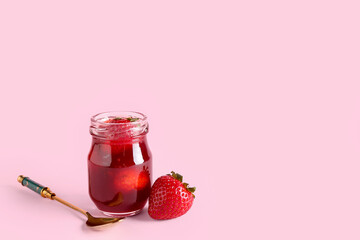 Jar of sweet strawberry jam on pink background