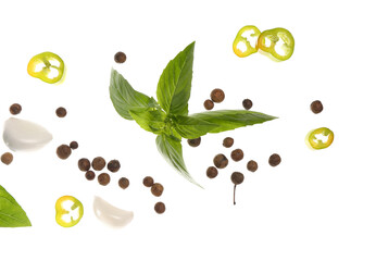 Flying spices and basil on white background