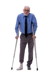 Old businessman with crutches isolated on white