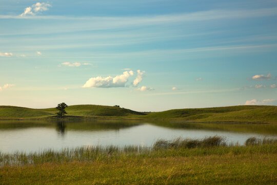 Green rolling hills on a picture perfect day in summer with a pond and blue sky near Stillwater Minnesota USA