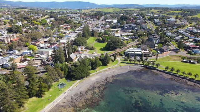 Aerial drone pullback reverse view of Kiama on the New South Wales South Coast, Australia showing  Kiama Harbour on a sunny day 