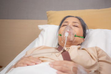 Patient elderly asleep with disease or unconscious in oxygen mask on bed at hospital ward, senior...