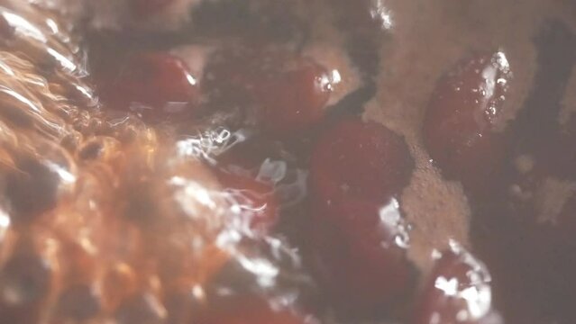 Close up red beans are being cooked in boiling water.