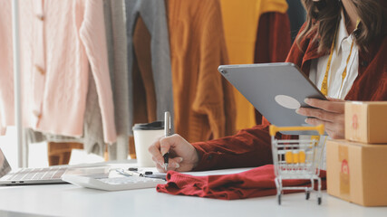 Portrait young attractive hipster asia female owner startup look at camera work happy with box at home prepare parcel delivery in sme supply chain, procurement, omnichannel ecommerce online concept.