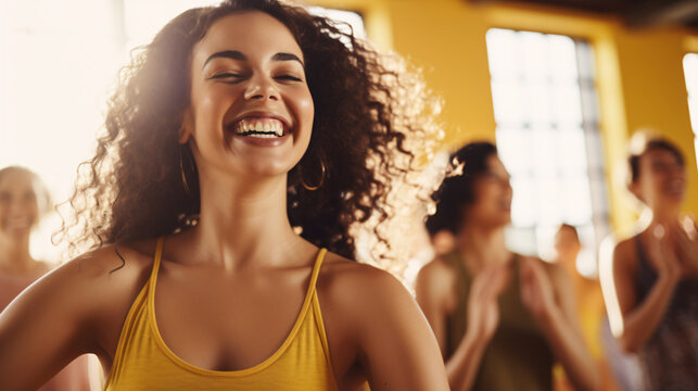 Attractive young women enjoying a joyful dance class with her friends in a blurred background 