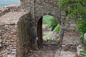 ancient gate surrounded by greenary 