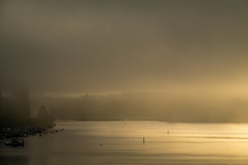 Stockholm, Sweden Fog and the sunrise over the Ridddarfjarden bay in downtown create a dramatic...