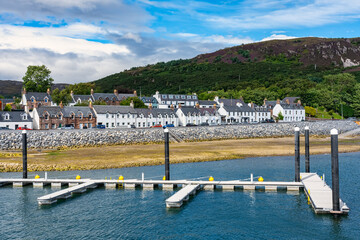 Panoramic view of the coastal town of Ullapool with its typical white houses and docks to dock...