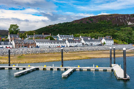 Panoramic view of the coastal town of Ullapool with its typical white houses and docks to dock boats, Scotland.