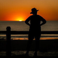 Fototapeta premium Silhouette of a person watching sunset in Broome, WA, Australia