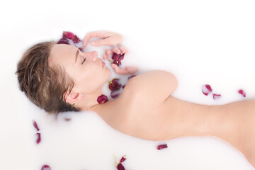 Obraz na płótnie Canvas Young woman body bathing in milk spa.