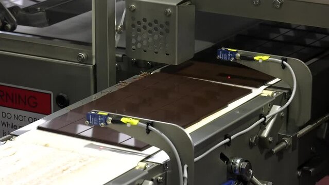 Chocolate factory. Conveyor for the production of chocolate bars. chocolate factory bars in line making by machine all automatic no human needed from liquid to solid on line