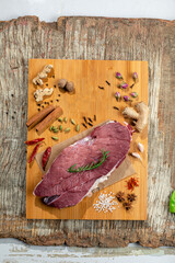 raw beef steak with rosemary on woody cutting board , from top view 5