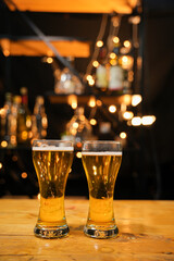 food and drink male friends are happy drinking beer and clinking glasses at a bar or pub.