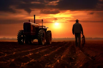 Foto op Canvas farmer in the field with tractor at sunset © sam