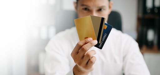 Financial owe, Asian man sitting, holding credit card, stressed by calculate expense from invoice...