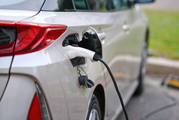 Charging of an electric car. EV car charge battery. Charging electric car socket. Electric car charging port closeup.