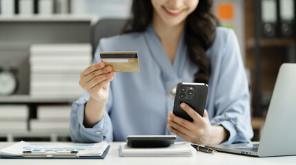 Closeup women holding hand credit card.businessman use smartphone online payments shopping in the morning.