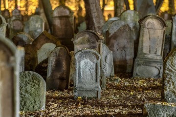 Tombstones in an old cemetery at night. - obrazy, fototapety, plakaty