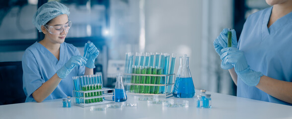 Modern Medical Research Laboratory, Researchers working in the clinical laboratory with analyzing test tube sample.