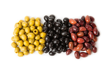 Green, black and red olives isolated on white background. Various types of olives and with fresh olive leaves. Mediterranean food. Vegan.