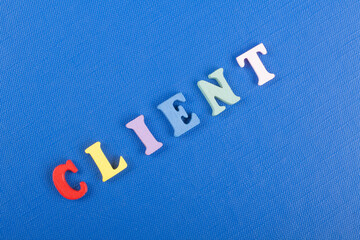 CLIENT word on blue background composed from colorful abc alphabet block wooden letters, copy space for ad text. Learning english concept.