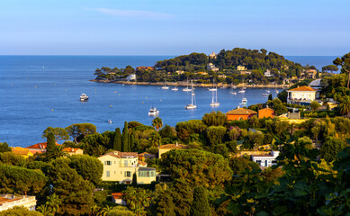 Fototapeta na wymiar Panoramic view of Saint-Jean-Cap-Ferrat resort town on Cap Ferrat cape with exclusive estates at French Riviera of Mediterranean Sea in France