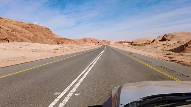 Al Ula, Saudi Arabia: Point of view of a car driving on the road through the Al Ula area, famous for its archeological sites in the desert of Saudi Arabia. 