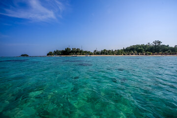  View of the beach at kho lipe. Natural stone arch and white beach  near Tarutao national park Satun Thailand.