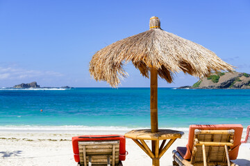 Beachside lounge chairs and umbrellas to relax and enjoy the beauty of the beach, Umbrellas made...