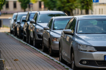 Cars parked next to paved street