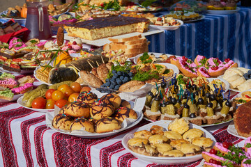 concept of a festive table with dishes,Ukrainian table with delicious snacks on the street, victory celebration