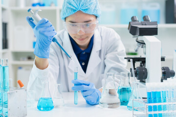 adult scientist using pipette dropping liquid samples into test tube analyzing biology pharmacy in laboratory, doctor student working research for technology innovation development in university