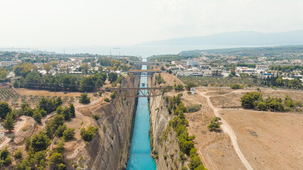 Fototapeta na wymiar Corinth Canal, Greece. The Corinth Canal is a sluiceless shipping canal in Greece, connecting the Saronic Gulf of the Aegean and the Gulf of Corinth of the Ionian Sea, Aerial View