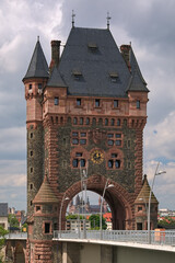 Worms, Germany. Nibelung Tower, a 53 metres tall neo-Romanesque bridge tower of Nibelungen Bridge over the Rhine. It was built in 1897-1900. Worms Cathedral is visible through the gateway of the tower