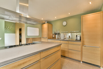 a modern kitchen with wood cabinets and stainless appliances on the counter tops in this photo is...