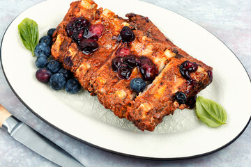 Grilled pork ribs with berry sauce.