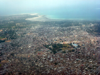 View from above of a huge city with many private houses below. View from the plane