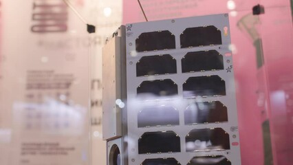 Layout or working model of a satellite for communication, navigation, or telecommunications from space. Assembly of the device at the factory. New space technologies. - Powered by Adobe